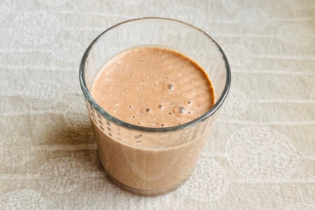 A creamy smoothie made with hazelnuts in a glass.