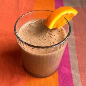 A chocolate orange smoothie in a glass.
