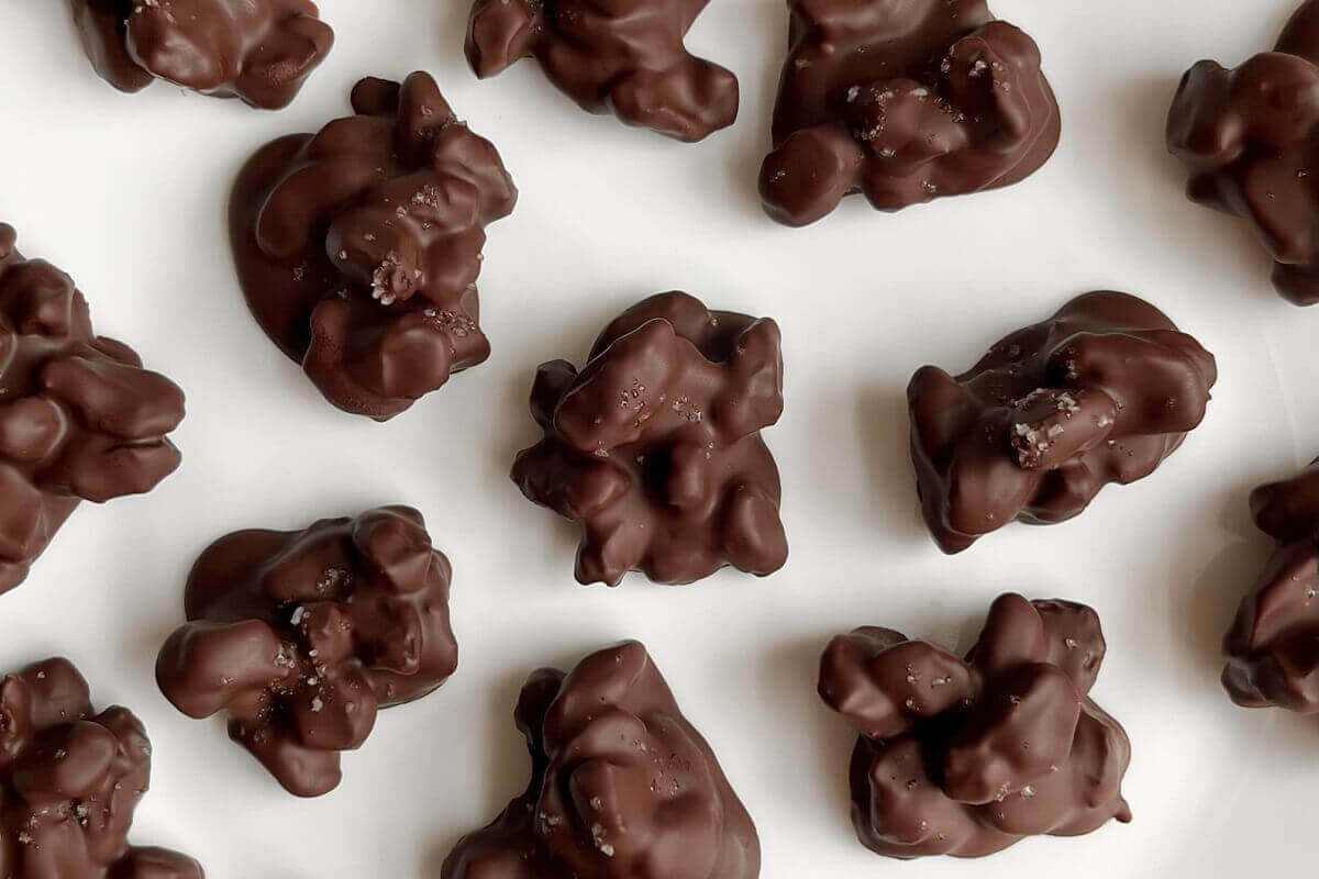 Chocolate raisin treats on a white plate.