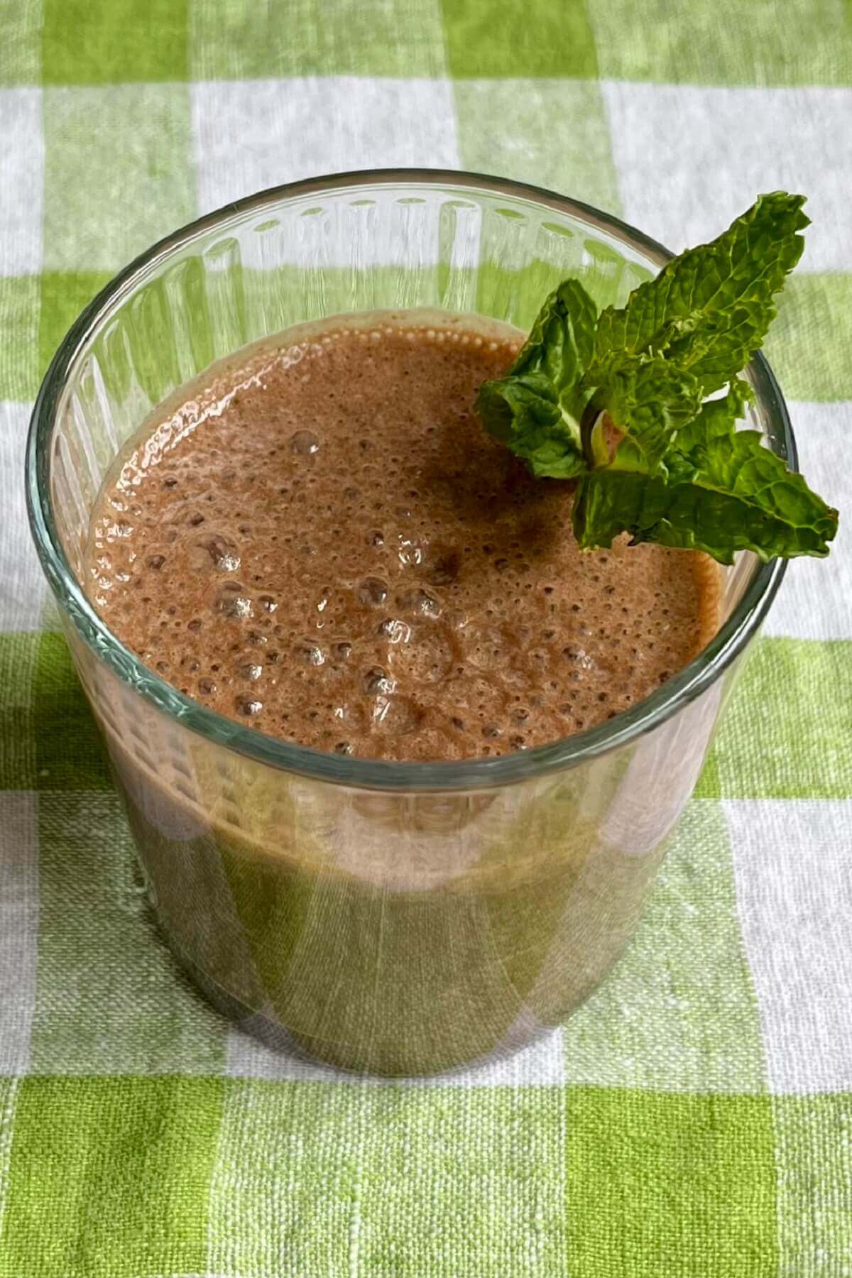 A cocoa mint shake in a glass.