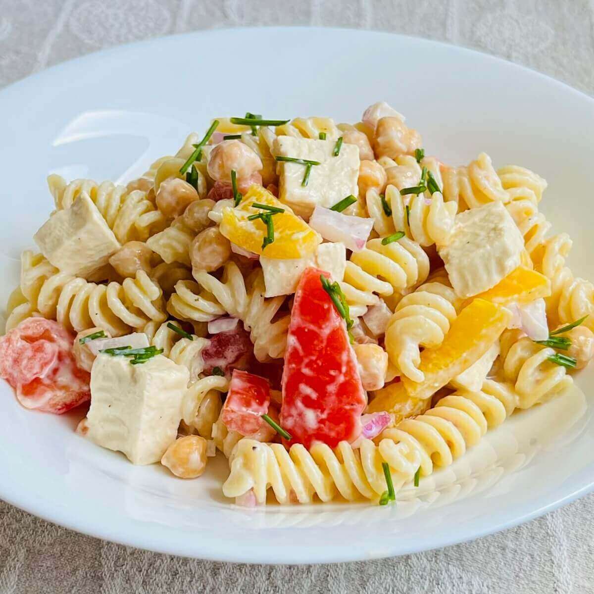 High protein vegan pasta salad in a white bowl.