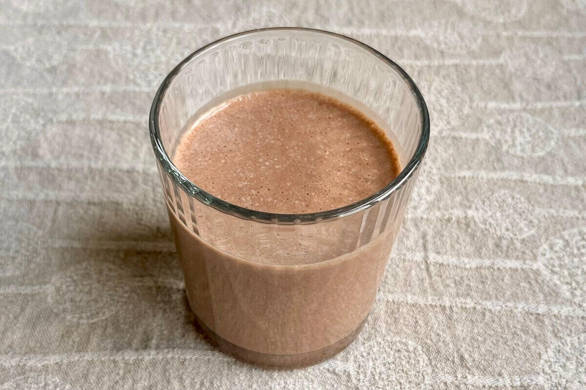 A smoothie made with tahini in a glass.