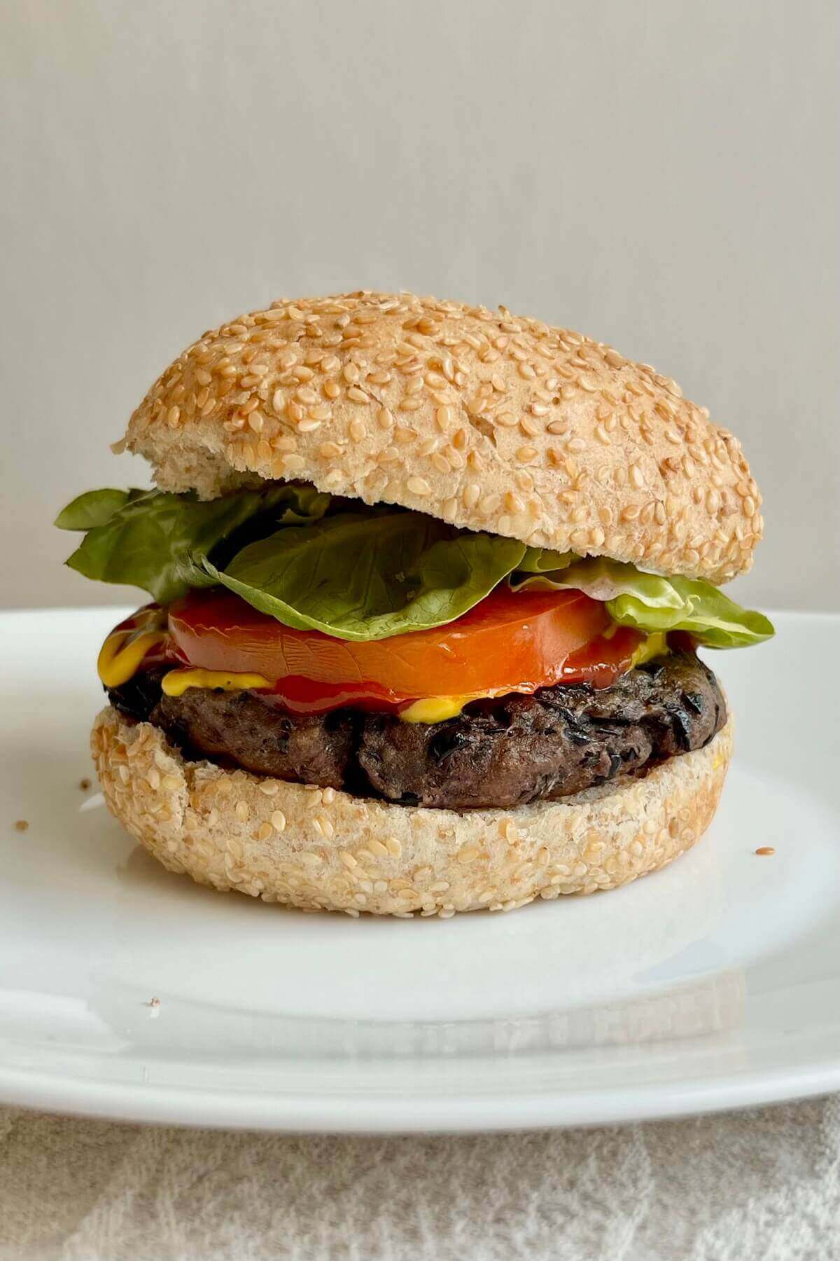 A high-protein vegan burger on a white plate.