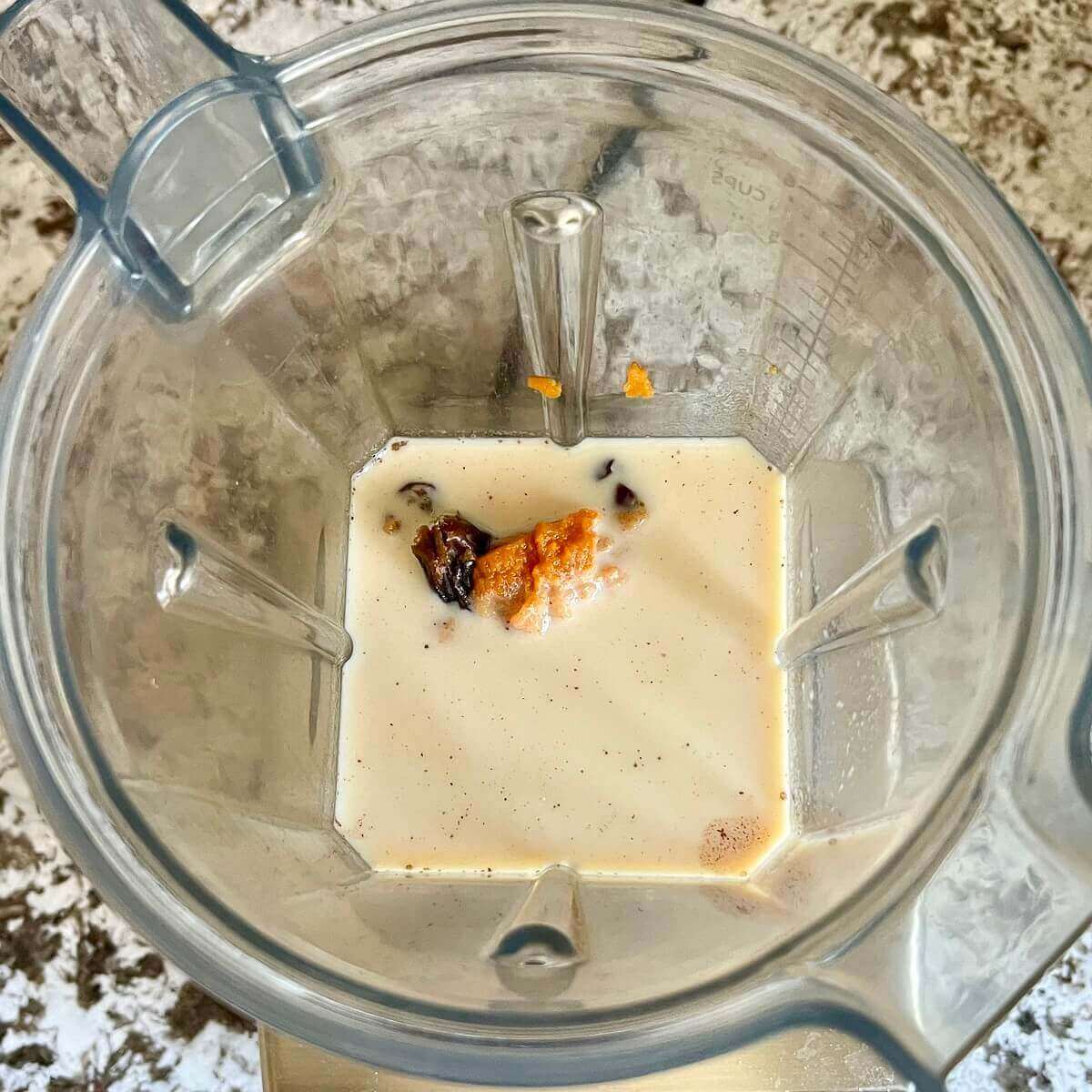 Pumpkin puree and other smoothie ingredients in a blender.