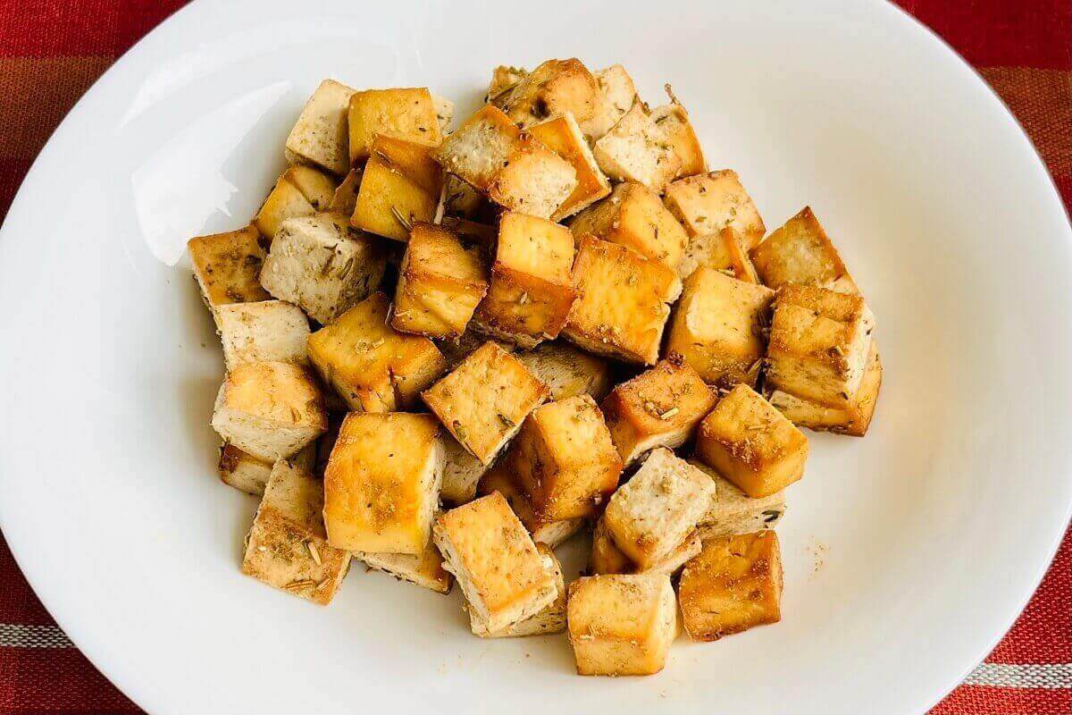 Baked tofu cubes in a white bowl.