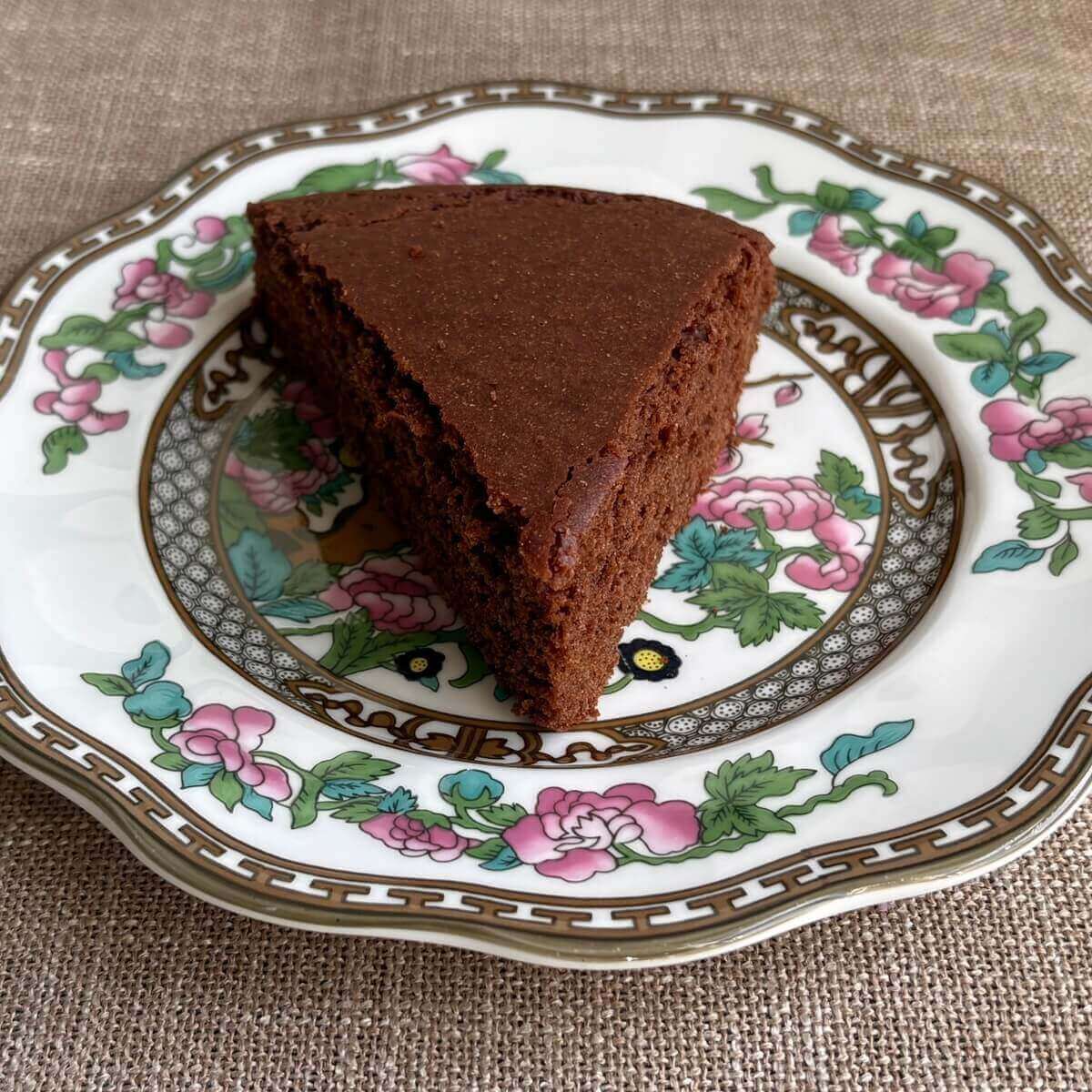 A slice of chickpea flour cake on a vintage plate.