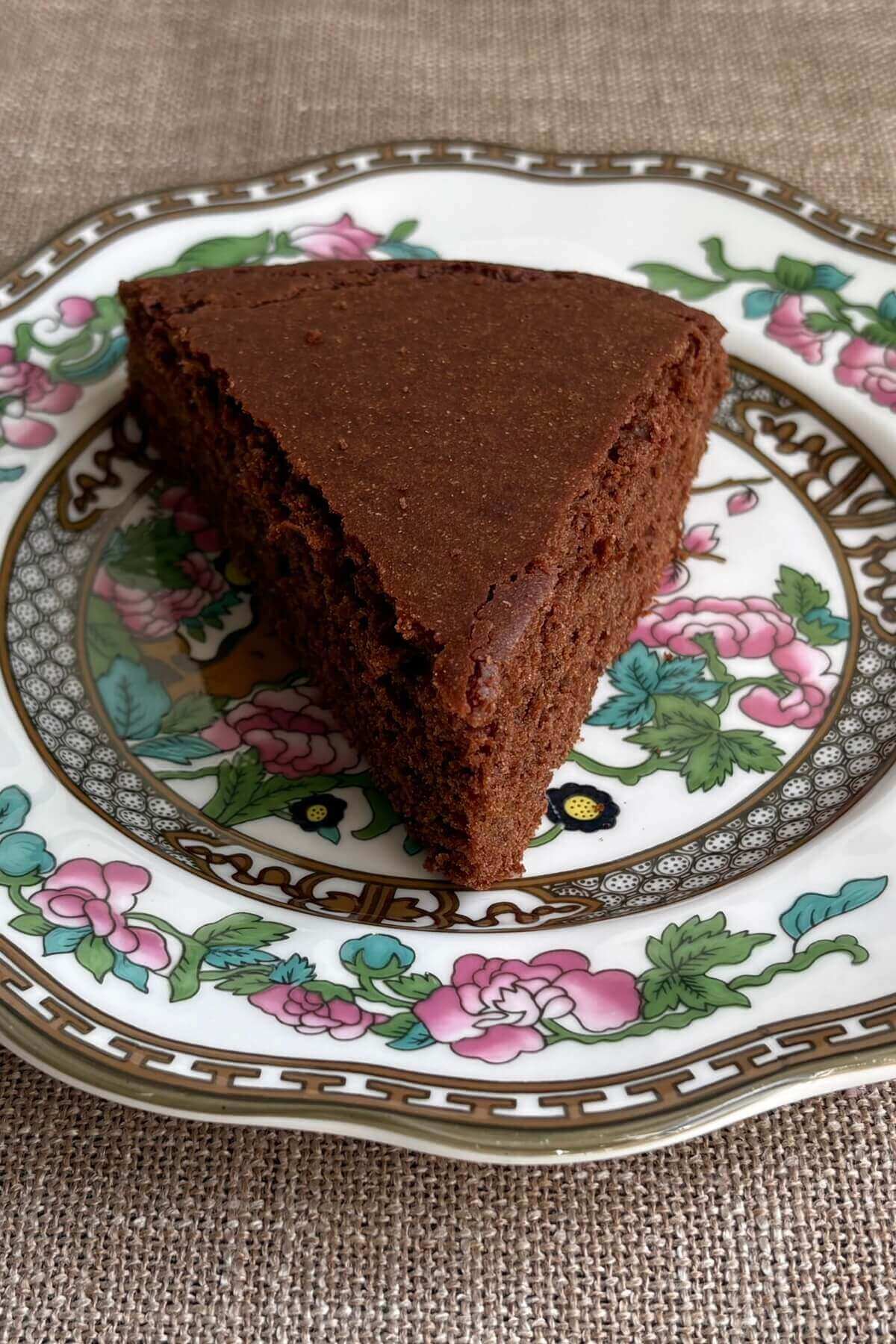 A slice of grain-free chocolate cake on a plate.