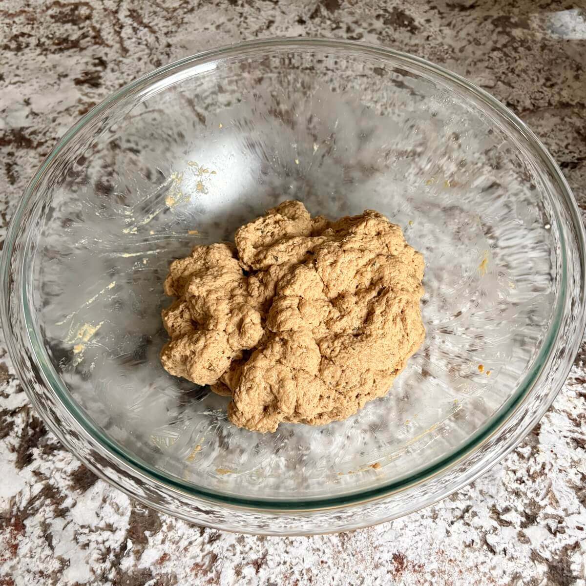 Dough for a vegan roast in a large glass mixing bowl.
