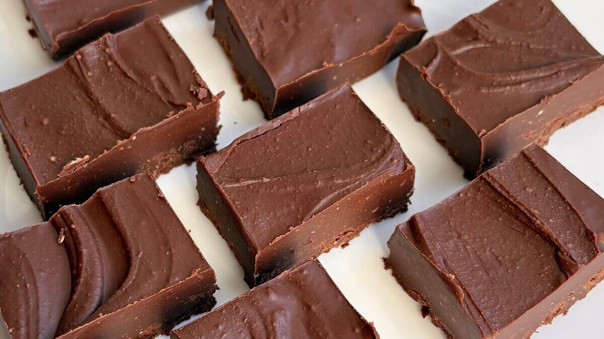Almond butter fudge portions on a white plate.