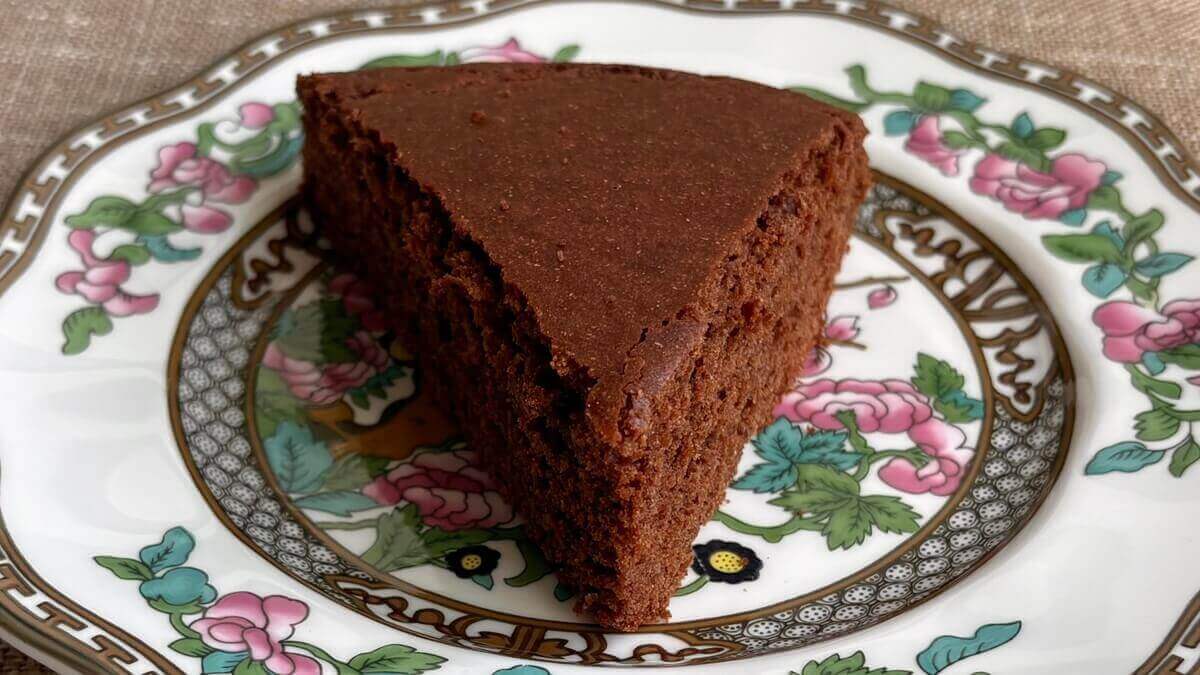 A slice of chickpea flour cake on a vintage plate.
