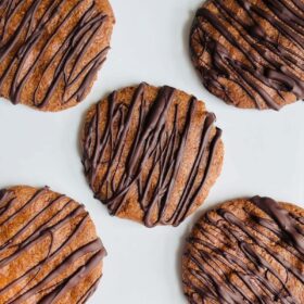 Five flaxseed cookies on a plate.
