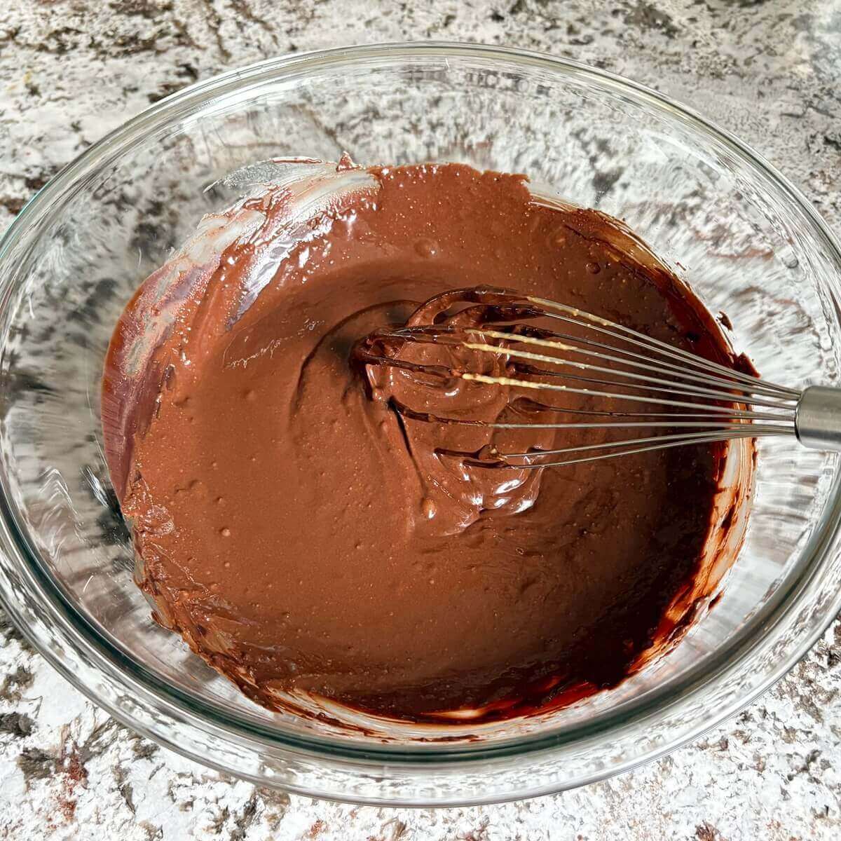 Low-carb fudge batter in a mixing bowl with a whisk.