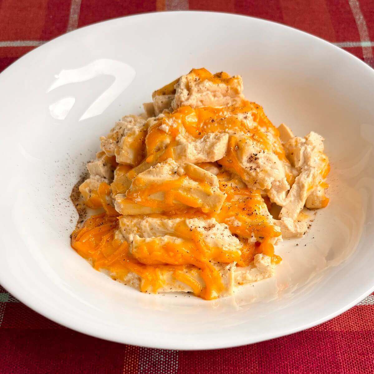 A serving of high-protein vegan mac and cheese in a white bowl.