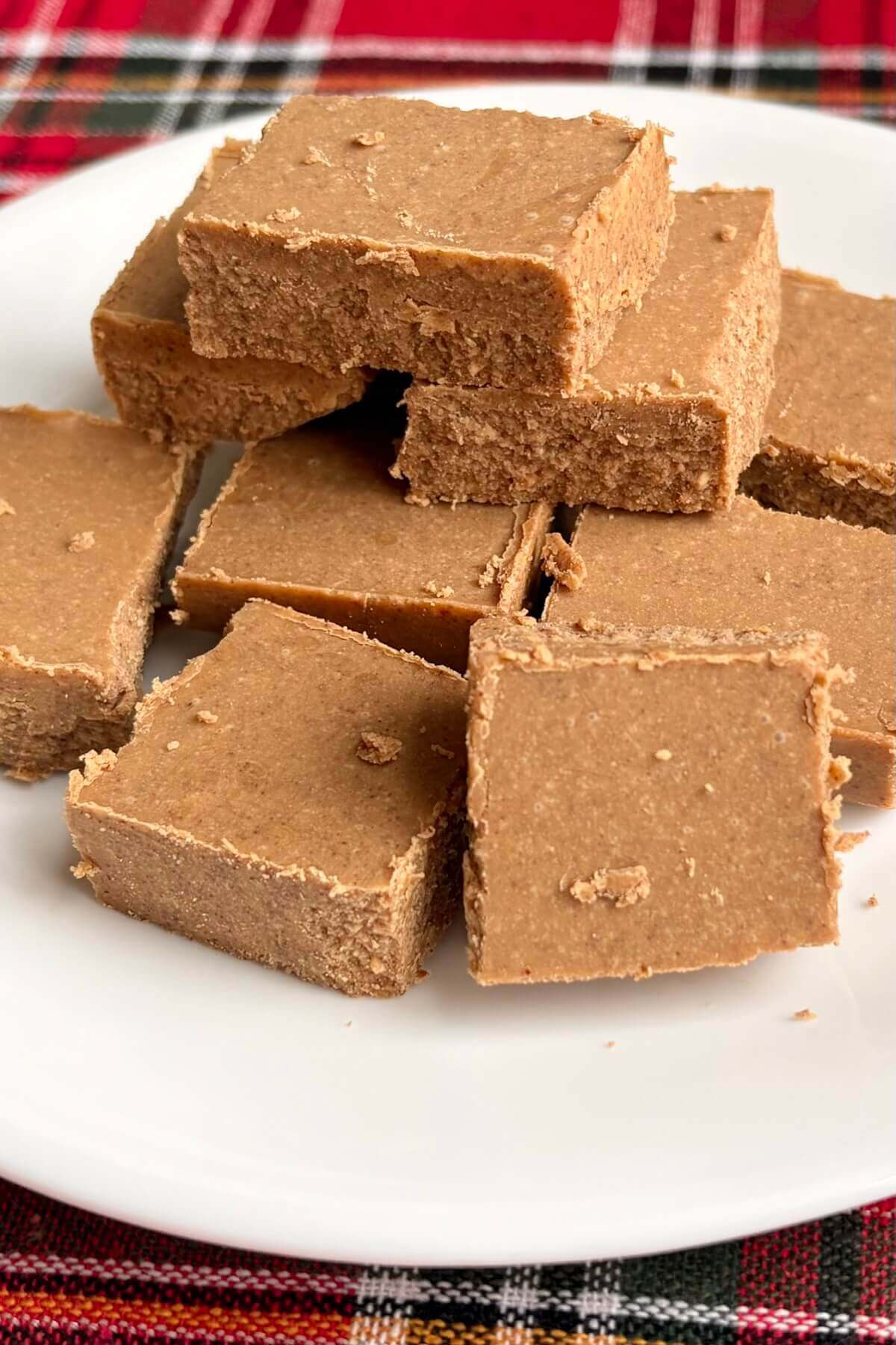 Squares of keto fudge on a white plate.