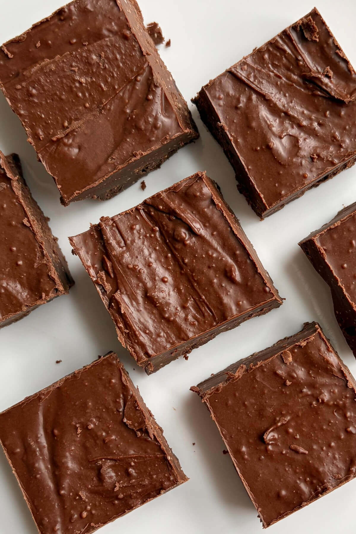 Keto fudge squares on a white plate.