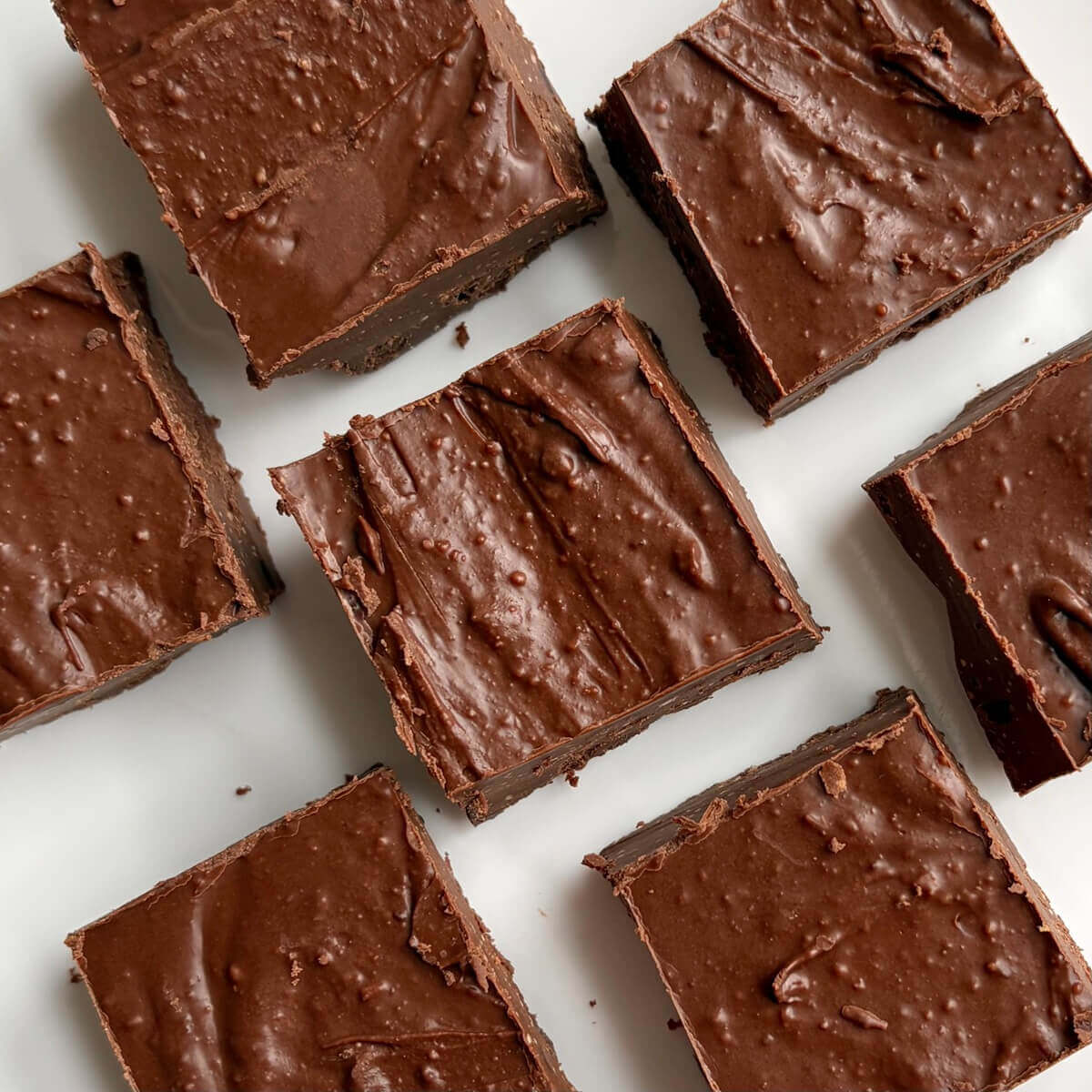Monk fruit fudge squares on a white plate.
