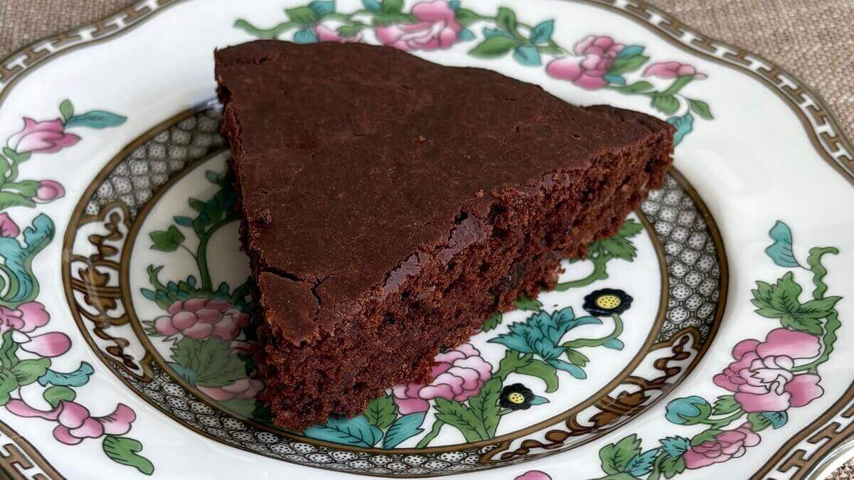 A slice of oat flour cake on a vintage plate.