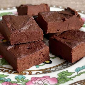 Squares of sweet potato fudge piled on a plate.