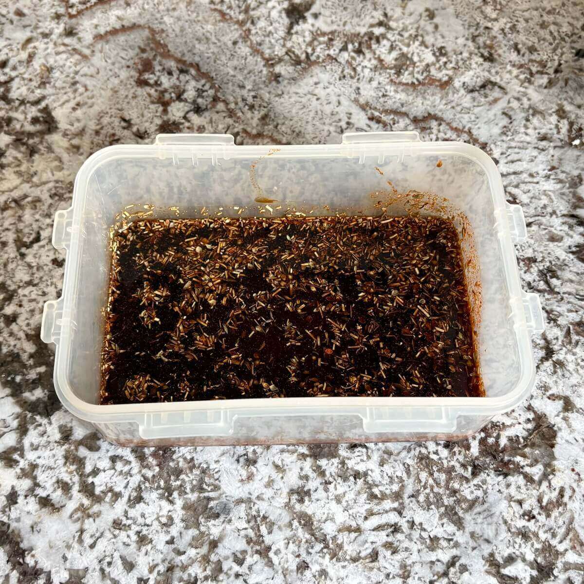 Tempeh marinade in a plastic container.