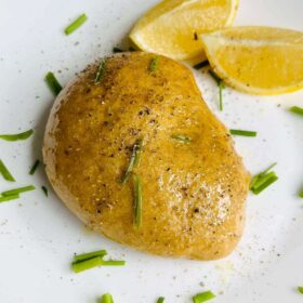 Vegan roasted chicken on a white plate.