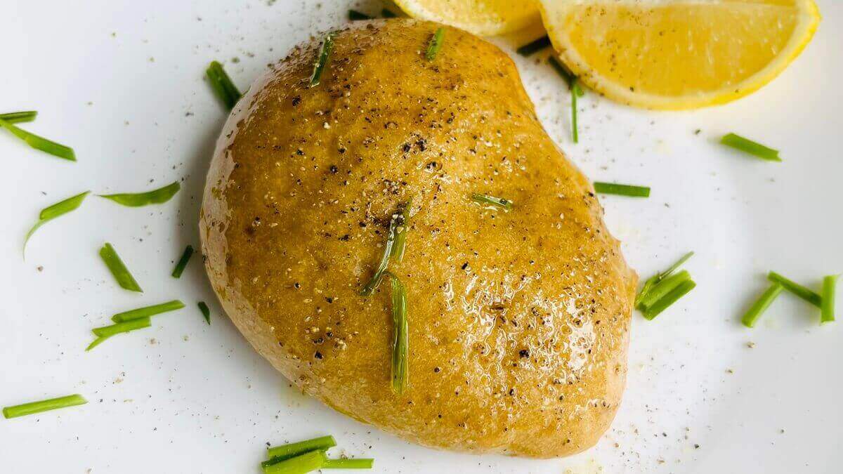 A serving of vegan roasted chicken sprinkled with chopped chives.