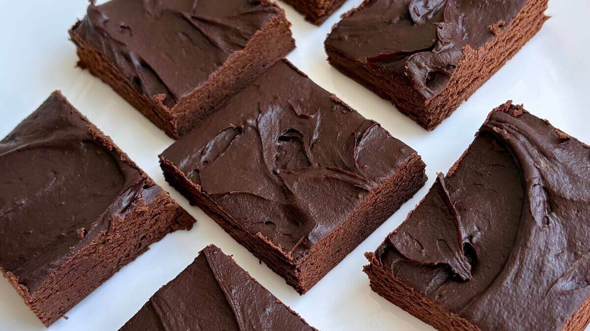 Squares of avocado chocolate fudge on a plate.