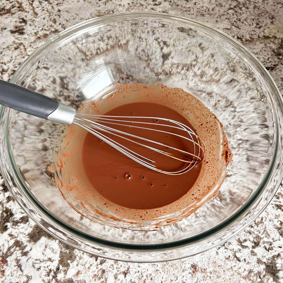 Ingredients for low-carb frosting in a glass mixing bowl.
