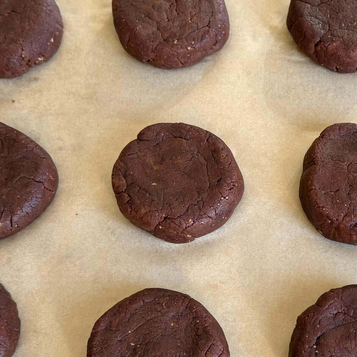 Raw low-carb cookies on a sheet pan lined with parchment paper.
