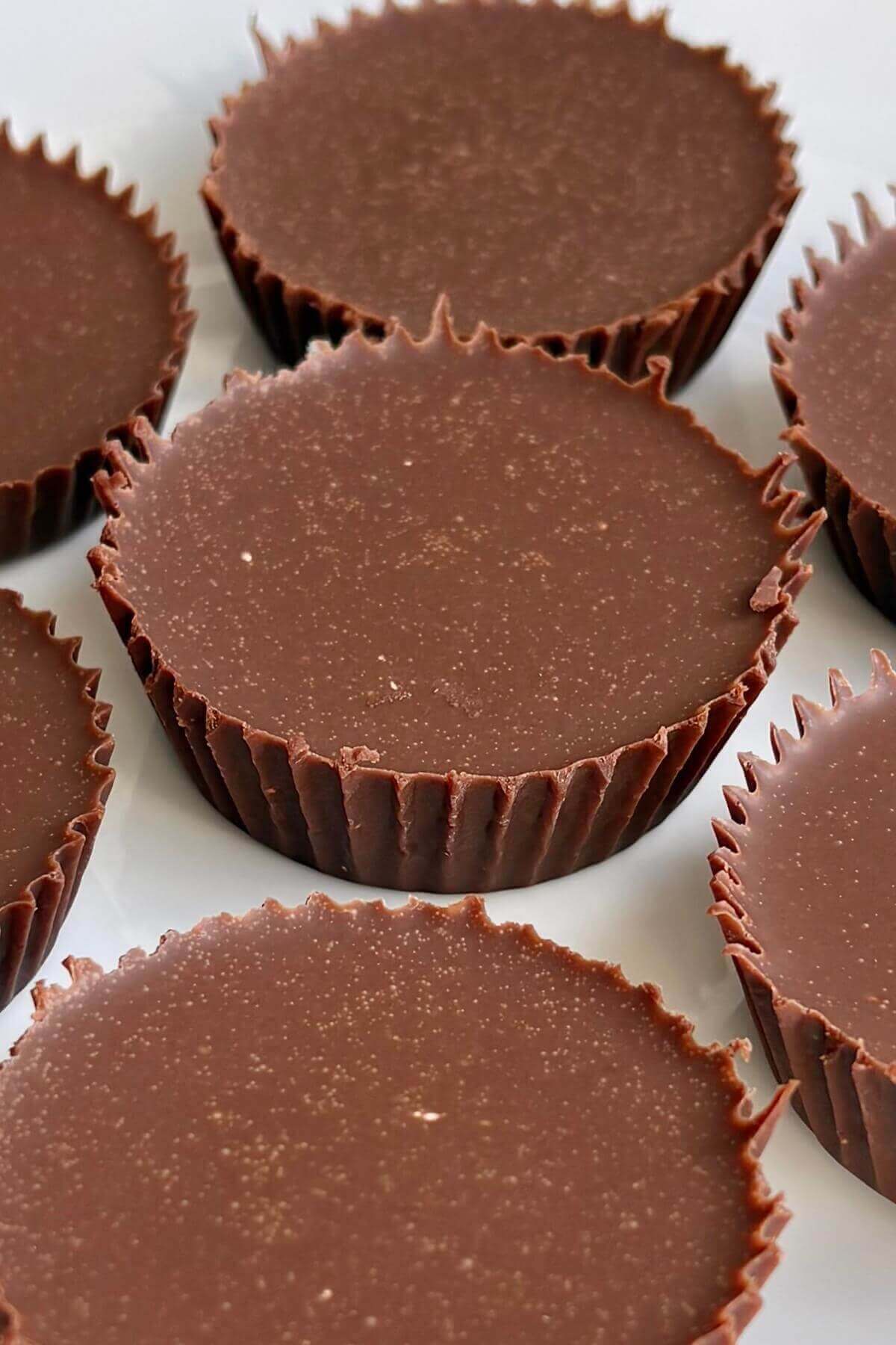 Chocolate fat bombs on a white plate.