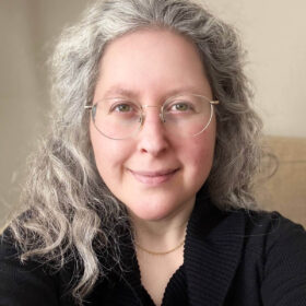 Jennifer Bell wearing a black sweater.