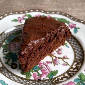 A slice of flaxseed cake on a vintage plate.