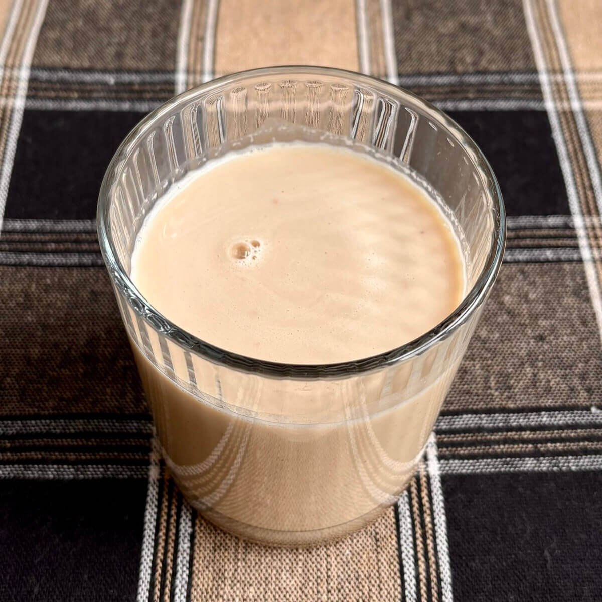 A powdered peanut butter shake in a glass.