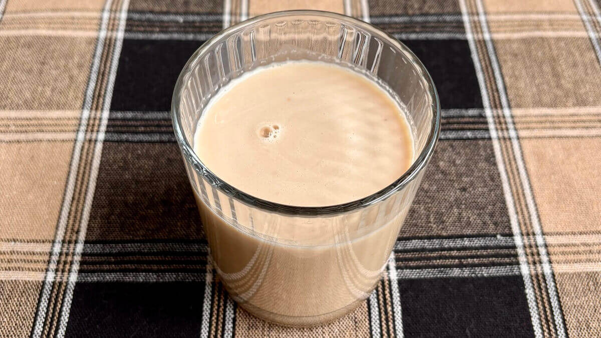 A powdered peanut butter smoothie in a glass.