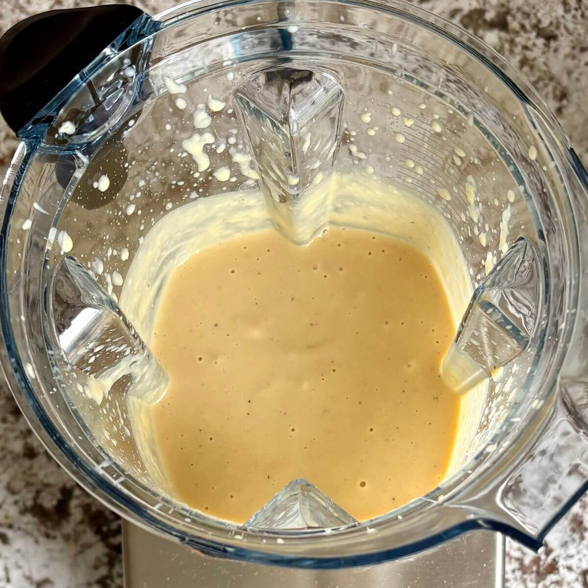 A creamy sauce made from chickpeas in a blender.