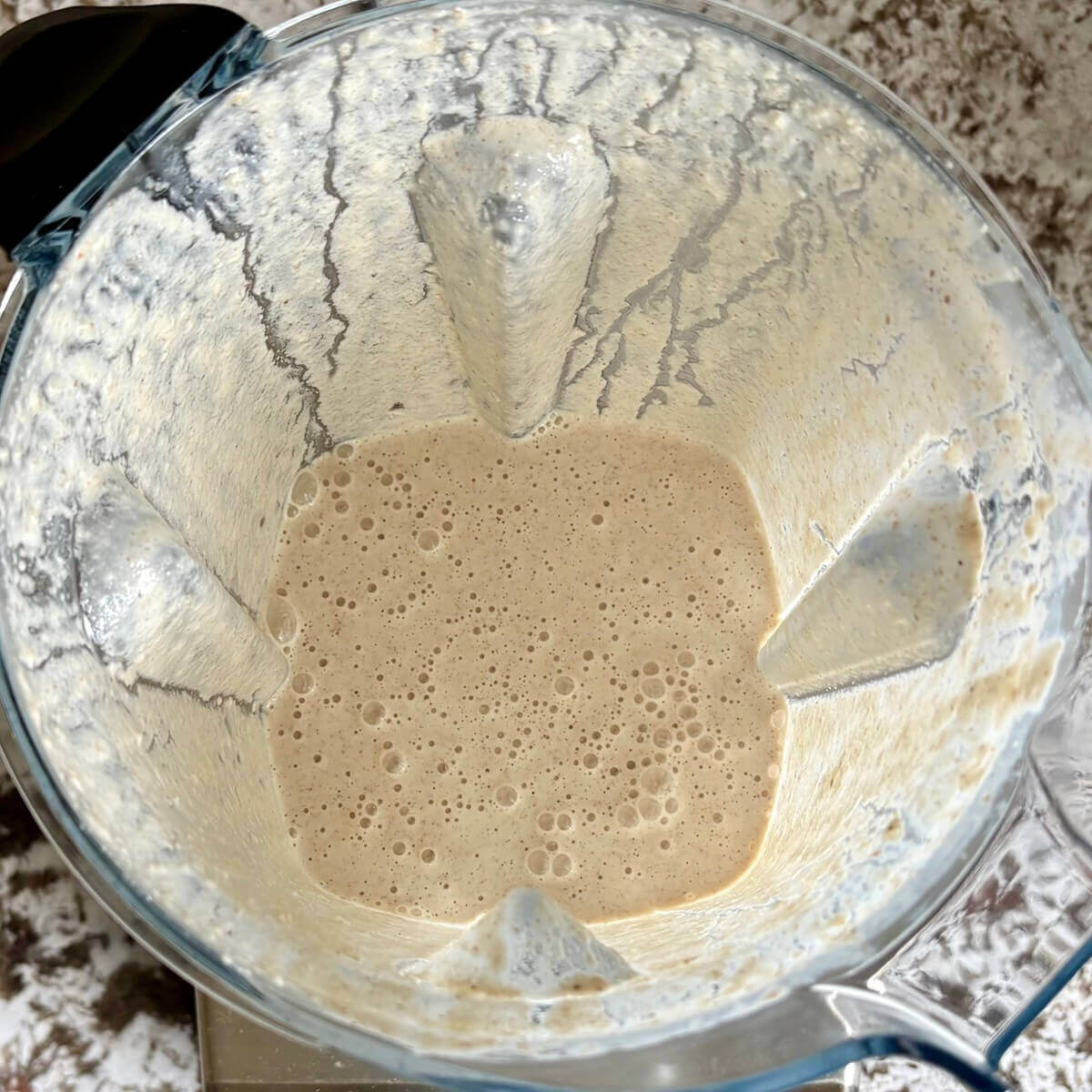Blended walnuts, water, and other ingredients in a blender.