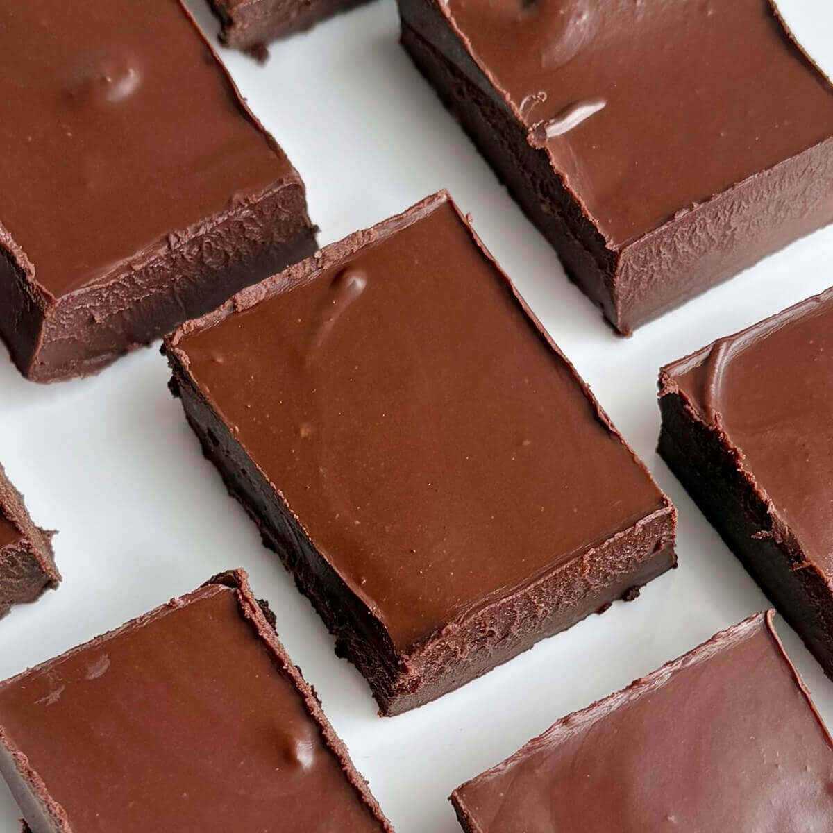 Cashew butter fudge squares on a white plate.