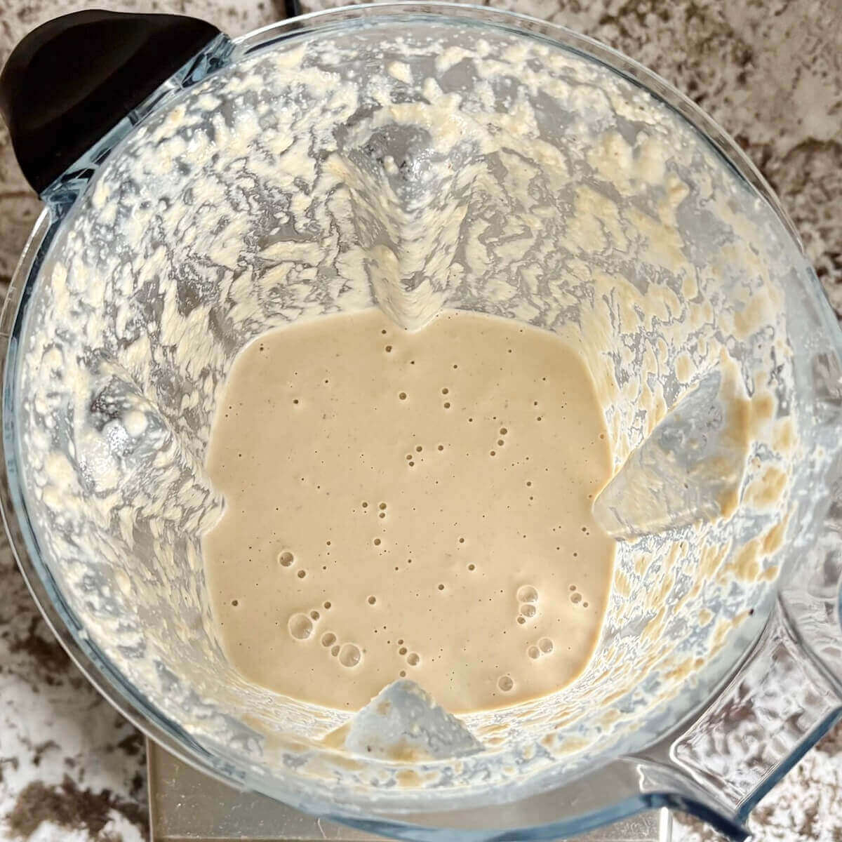 Creamy vegan sauce made with cashews in a blender.