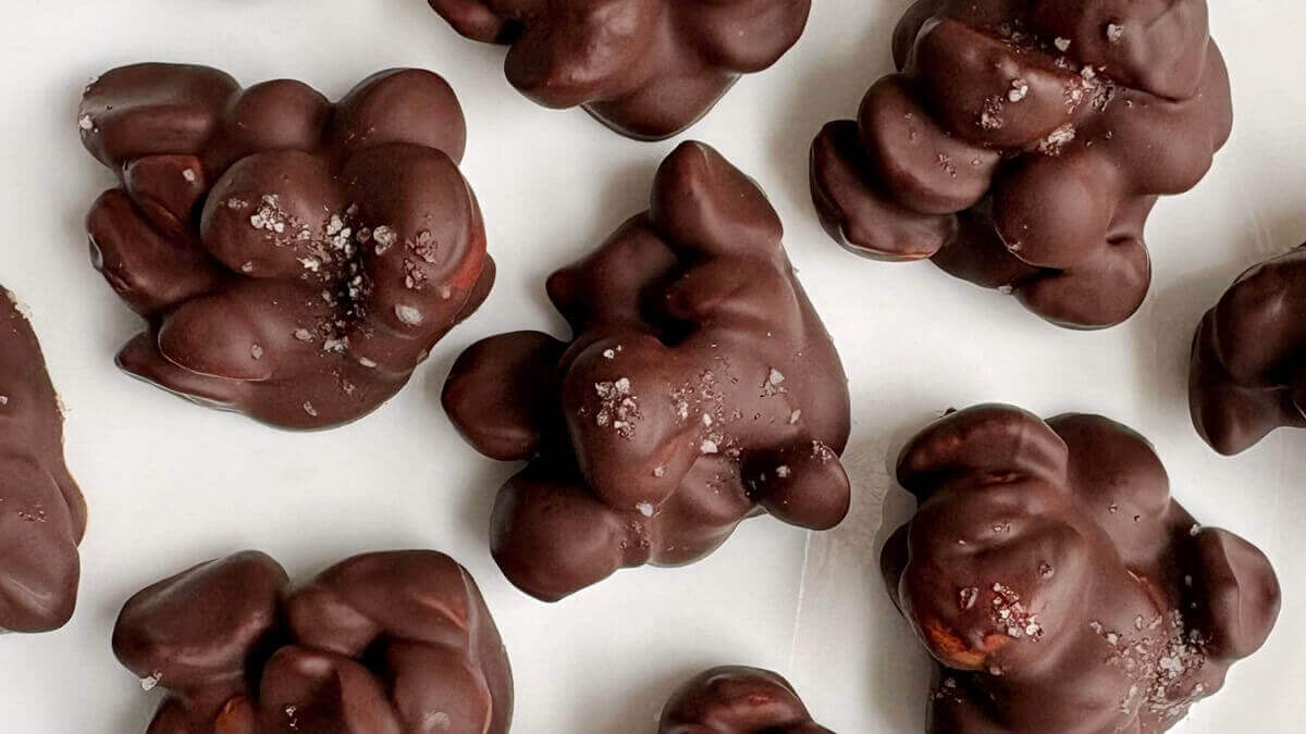 Macadamia chocolate treats on a white plate.