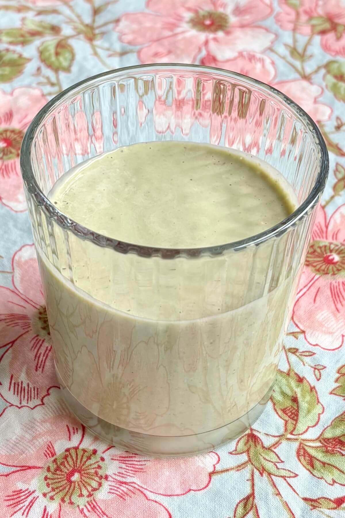 An oat avocado smoothie in a glass.