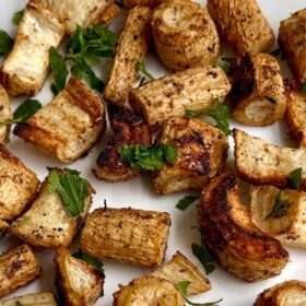 Roasted parsley root on a white plate.