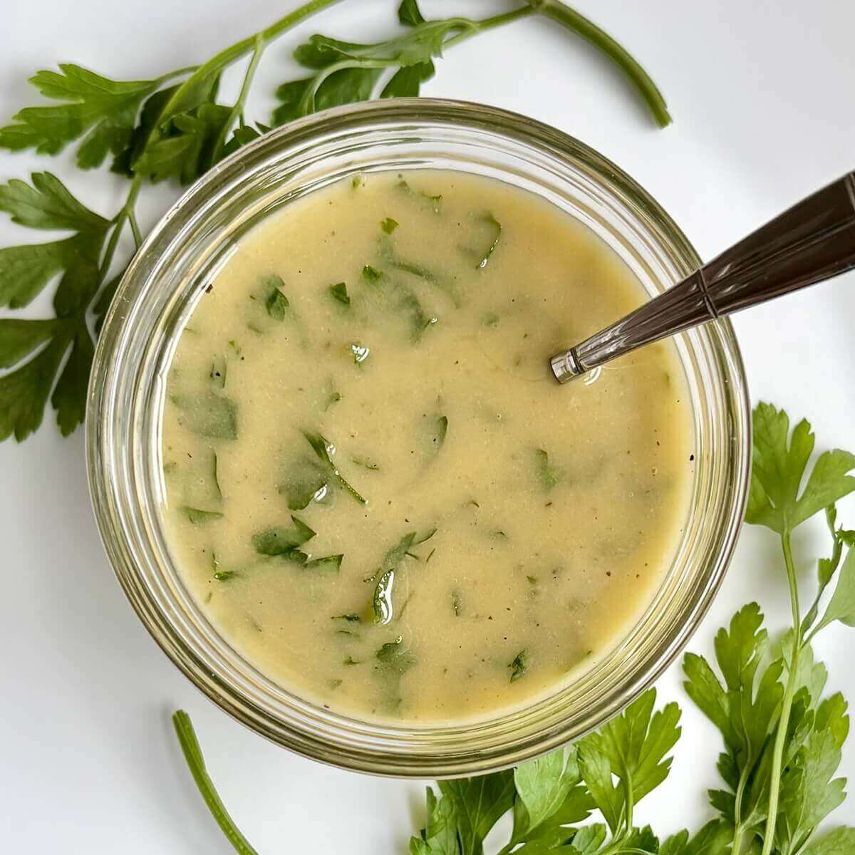 Parsley salad dressing in a glass dish.