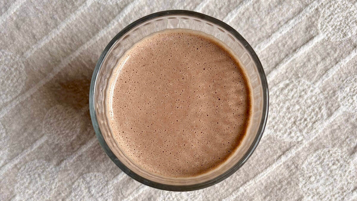 A peanut butter cup chocolate smoothie in a glass.