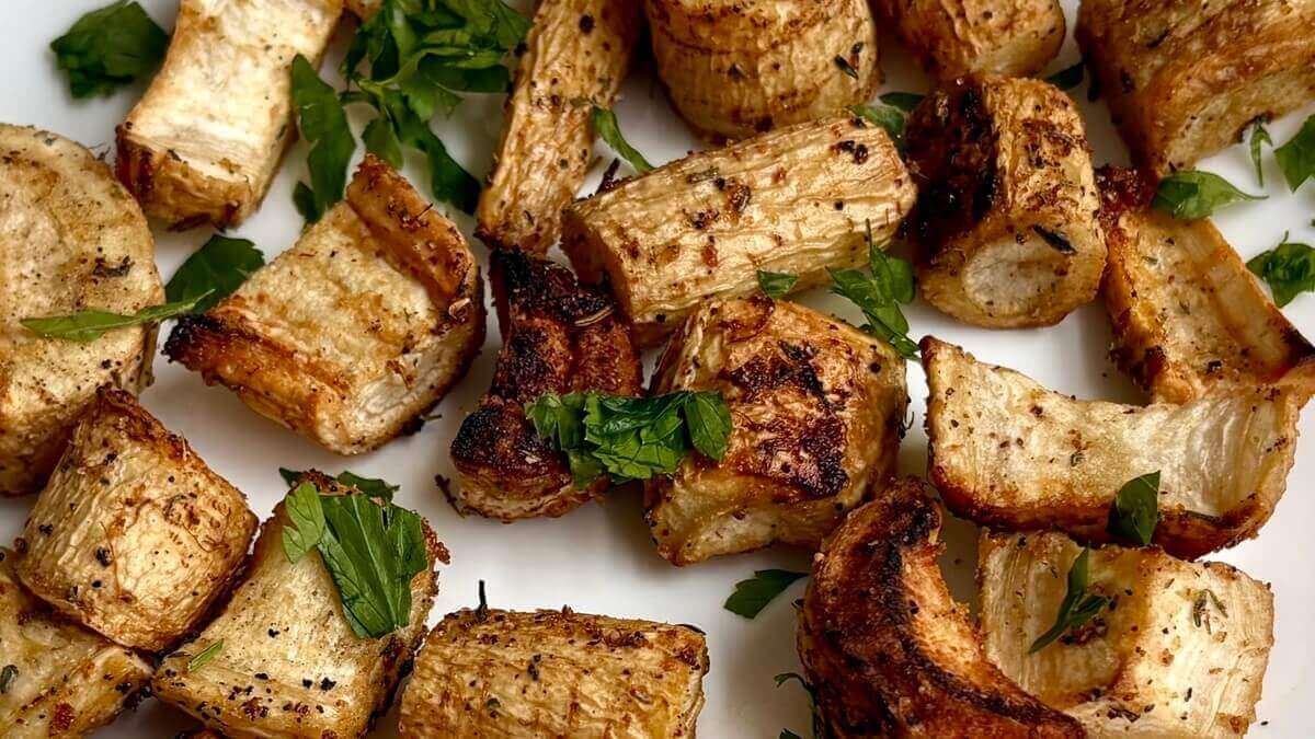 Roasted pieces of parsley root on a plate.