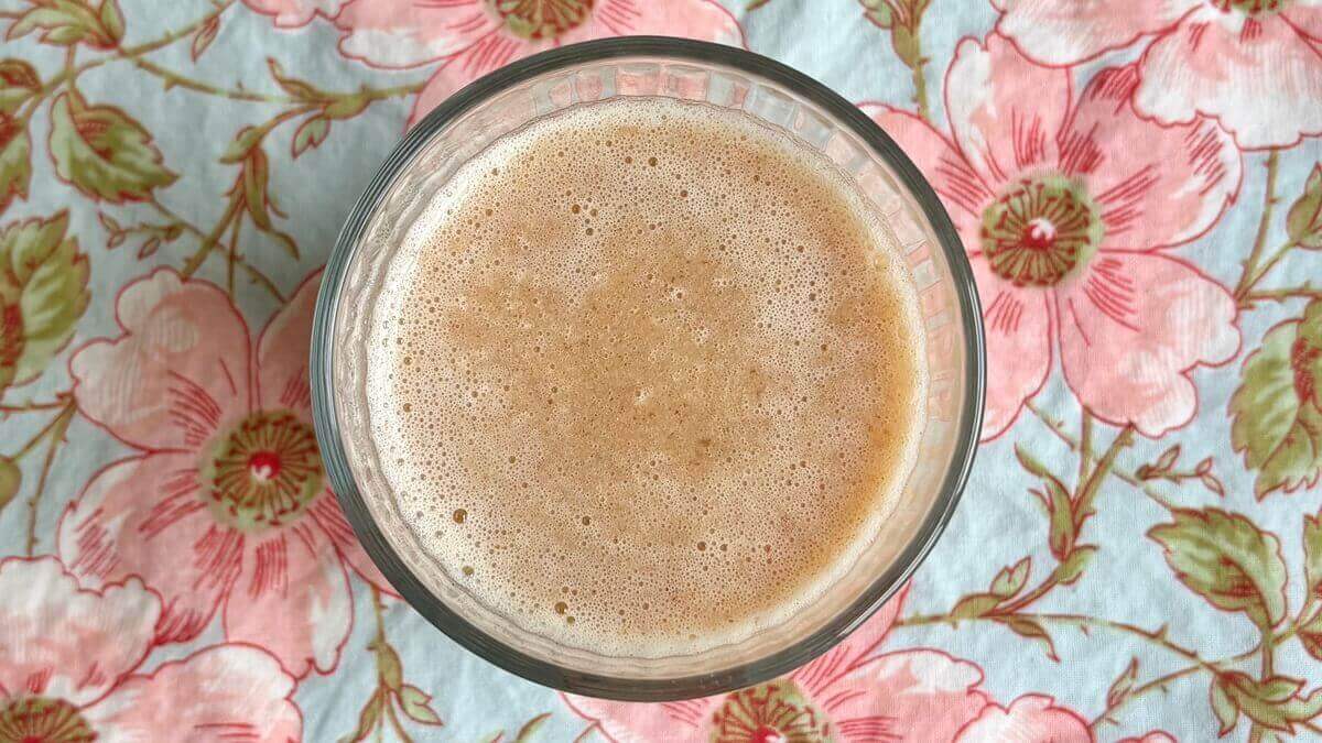 A smoothie made with whole lemon in a glass.