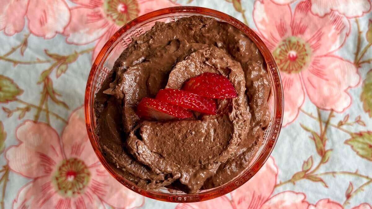 Chia mousse in a dish on a floral placemat.