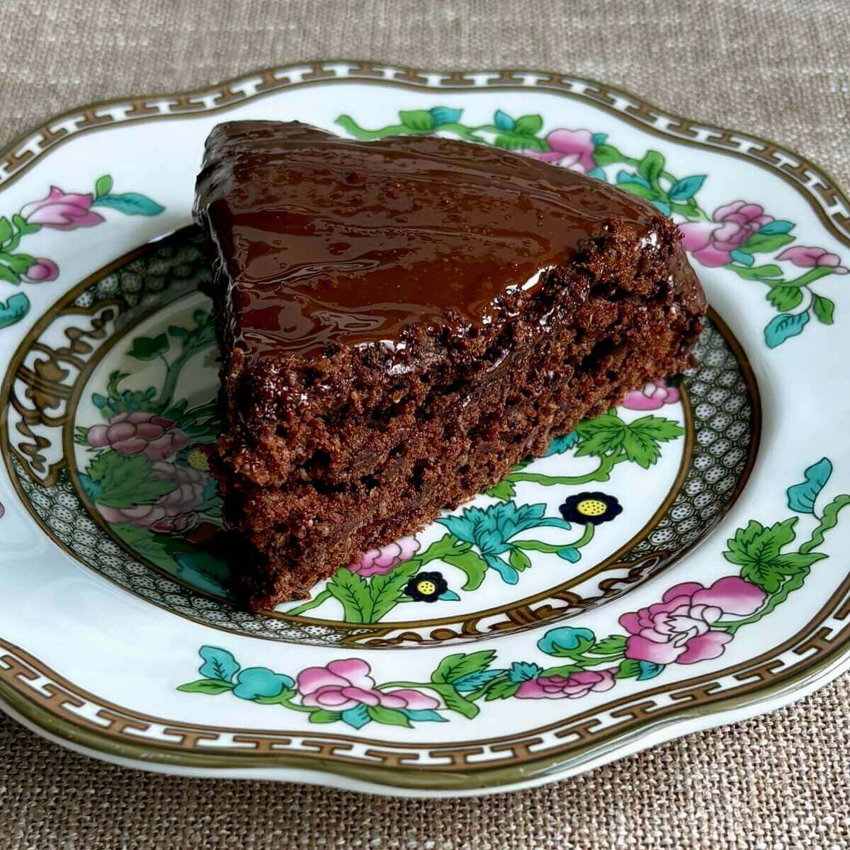 A slice of chia seed cake on a vintage plate.