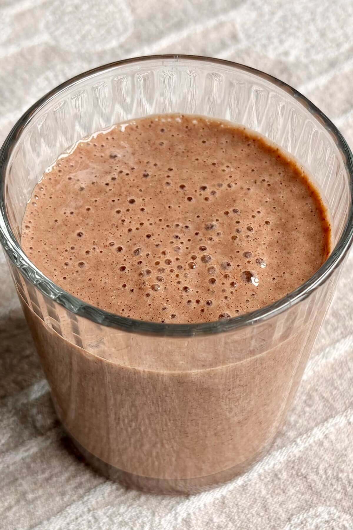 A creamy chia seed chocolate smoothie in a glass.