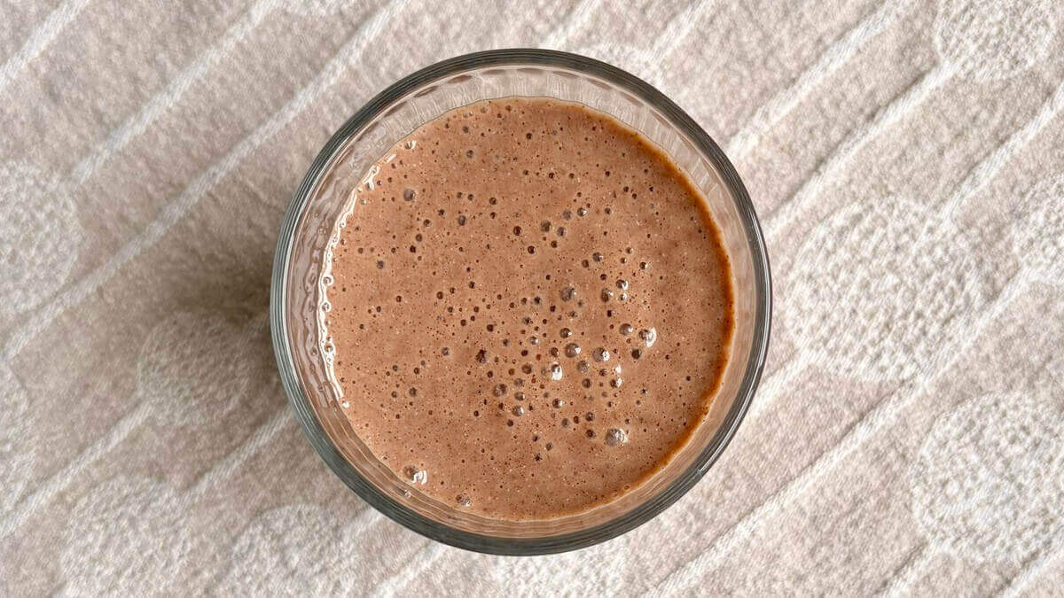 A chocolate chia seed smoothie in a glass.