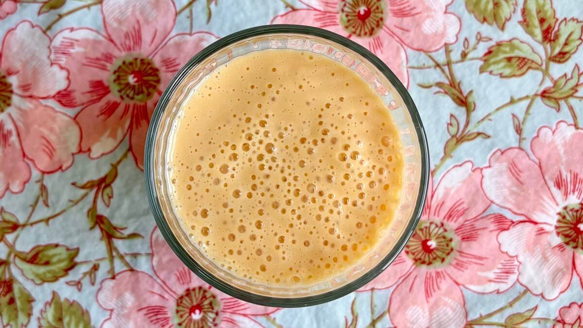 A creamy mango shake in a glass.