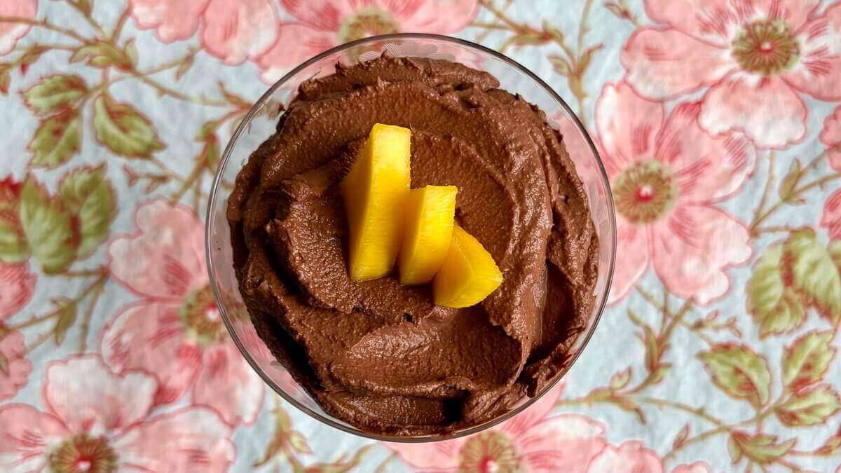 Mango mousse in a glass dish.